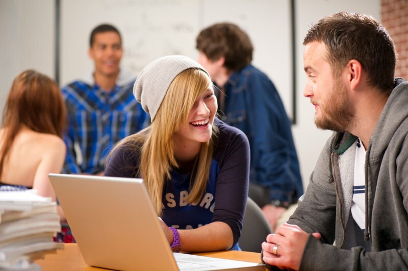 Photo of people at desk laughing